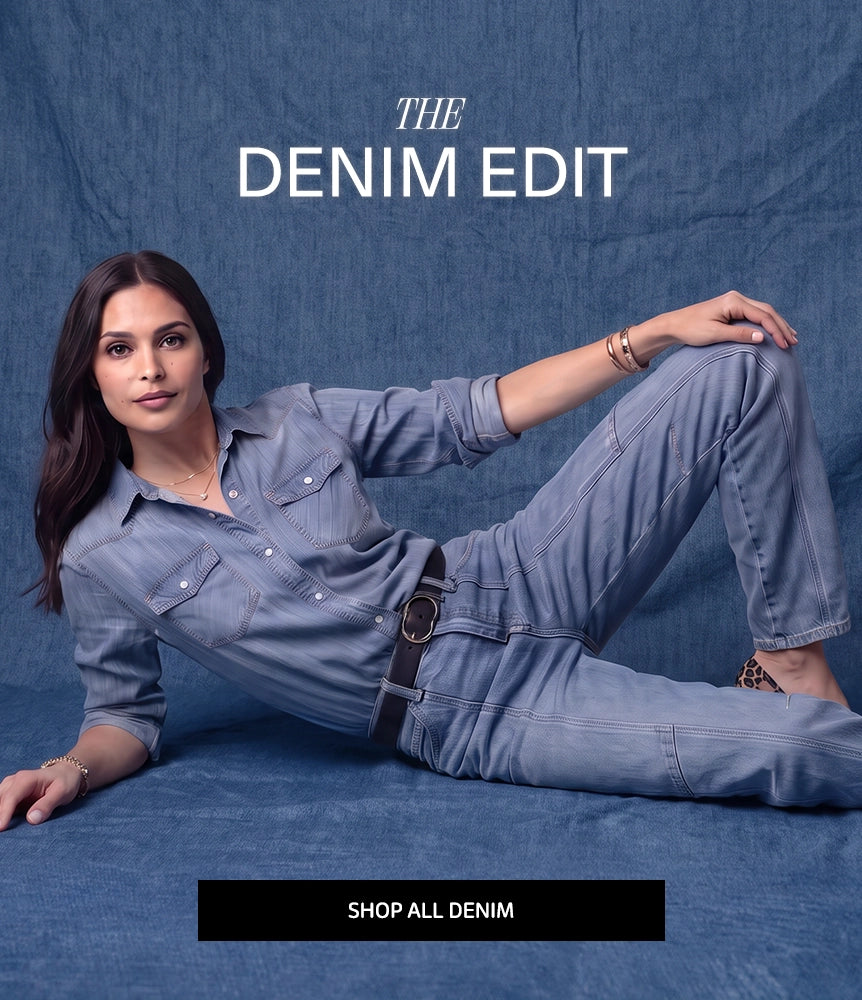 A woman reclining on a blue denim backdrop wearing a matching light blue denim shirt and jeans with a black belt. Large text reads 'THE DENIM EDIT' at the top, and a black bar at the bottom says 'SHOP ALL DENIM'.